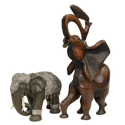 Lot 443 - Large carved wooden elephant, and a modern resin and white metal elephant statue