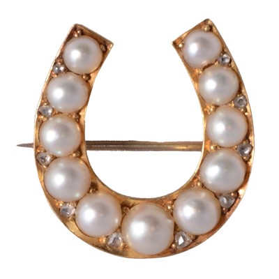 Lot 210 - A pearl set horseshoe brooch.