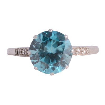 Lot 31 - A heat treated blue zircon solitaire ring and pair of earscrews.