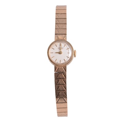 Lot 457 - Longines - a lady's 9 carat yellow gold bracelet wristwatch.