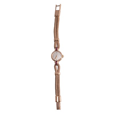 Lot 332 - Omega - a lady's yellow metal manual wind wristwatch with cord strap.
