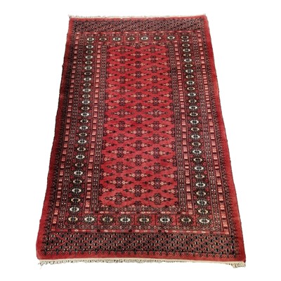 Lot 555 - Bokhara red ground rug, some damage 98cmx158cm.