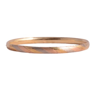 Lot 235 - A modern tri-colour half hinged bangle marked 585.