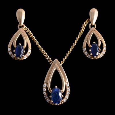 Lot 330 - A sapphire and diamond pendant and matching earrings.