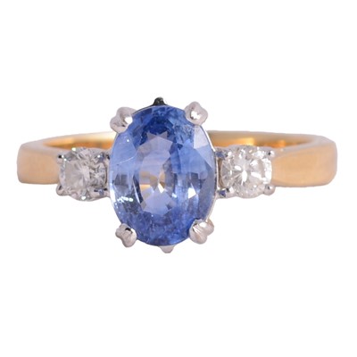 Lot 17 - A sapphire and diamond three stone ring.