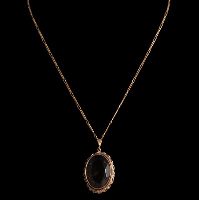 Lot 346 - A smoky quartz pendant on a chain.