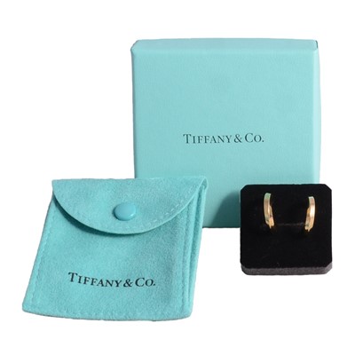 Lot 183 - Tiffany - a pair of 18 carat yellow gold hoop earrings.