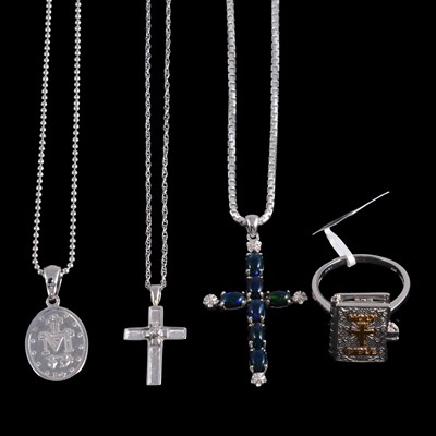 Lot 406 - A collection of gold, silver, and white metal religious pendants, some on chains, and a ring.