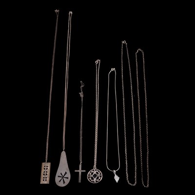 Lot 518 - A collection of silver and white metal pendants and chains.
