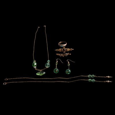 Lot 374 - A gemset ring, two gold brooches, and an uranium and clear glass bead suite of jewellery.