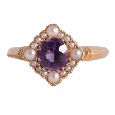 Lot 77 - An early 20th century pearl and amethyst dress ring.