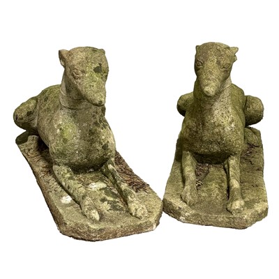 Lot 529 - Pair of stone garden ornaments of recumbent hounds