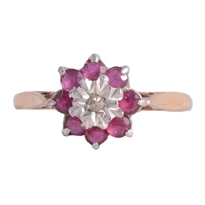 Lot 19 - A ruby and diamond reverse cluster ring.