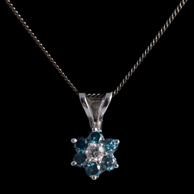 Lot 215 - A blue diamond cluster pendant on a chain.