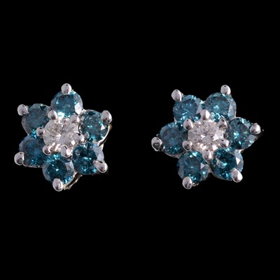 Lot 216 - A pair of blue diamond cluster earrings.