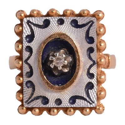 Lot 127 - A yellow and white metal ring with blue enamel decoration.