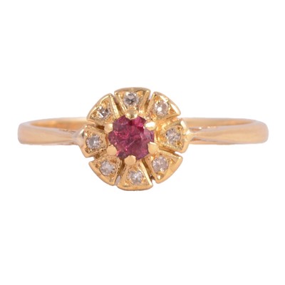 Lot 11 - A ruby and diamond cluster ring.