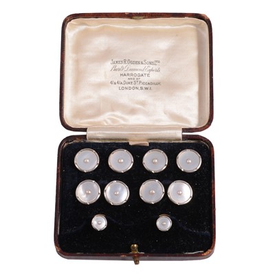 Lot 399 - A set of pearl, mother-of-pearl and yellow metal cufflinks and dress studs.