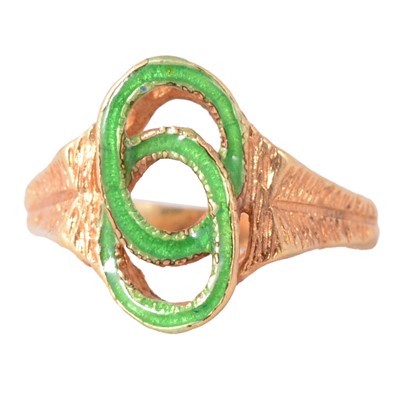 Lot 105 - A yellow metal and green enamel dress ring.