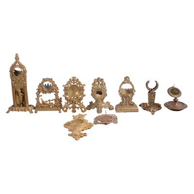 Lot 131 - Collection of cast brass and gilt metal watch stands, mostly 19th century