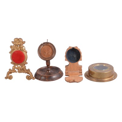 Lot 132 - Two small boxes of wooden and brass watch stands