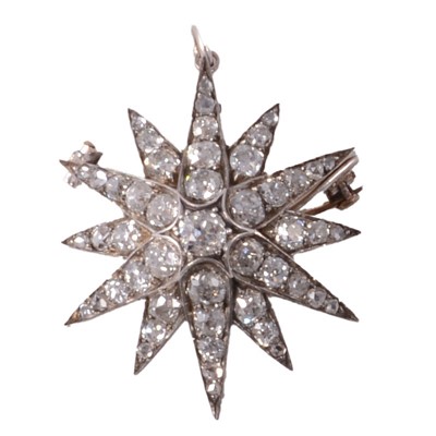 Lot 133 - A Victorian diamond twelve ray star brooch / pendant.