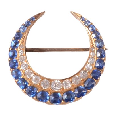 Lot 141 - A sapphire and diamond closed crescent brooch.