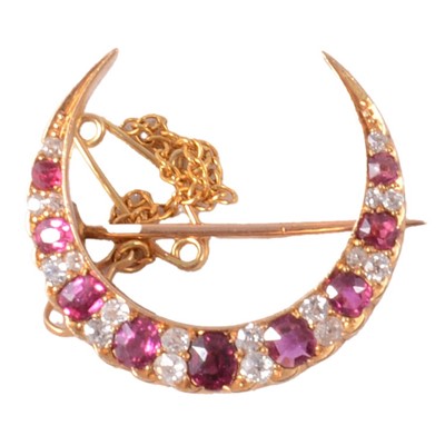 Lot 142 - A Victorian ruby and diamond open crescent brooch.