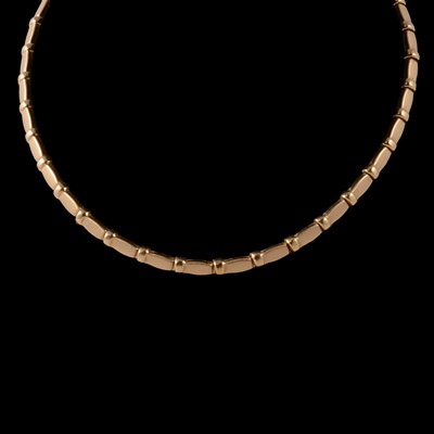 Lot 218 - An 18 carat yellow gold articulated necklace and matching bracelet.