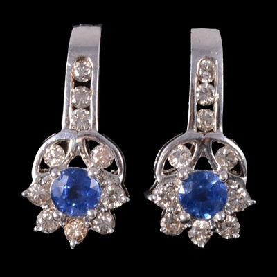 Lot 254 - A pair of sapphire and diamond floral design earclips.