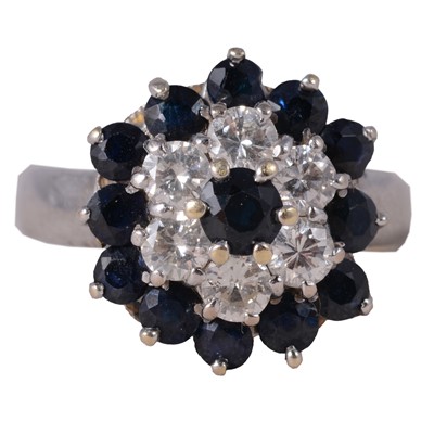 Lot 7 - A sapphire and diamond reverse cluster ring.