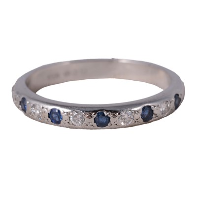 Lot 4 - A sapphire and diamond half eternity ring.