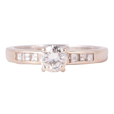 Lot 50 - A diamond solitaire ring with diamond set shoulders.