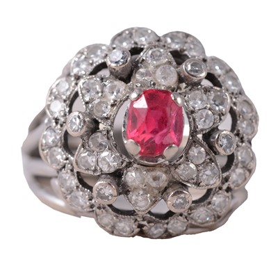 Lot 30 - A red stone and diamond cluster ring.