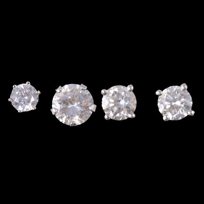 Lot 248 - A pair of diamond solitaire earstuds, and two synthetic white stone (not diamond) earstuds.