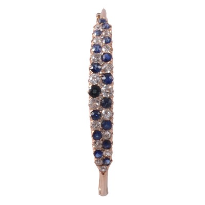 Lot 164 - A sapphire and diamond half hinged bangle.