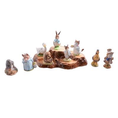 Lot 33 - Nine Beswick Beatrix Potter character figurines, plus a Beswick tree-stump display stand