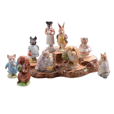 Lot 32 - Nine Beswick Beatrix Potter character figurines, plus a Beswick tree-stump display stand