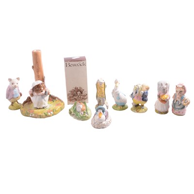 Lot 34 - Nine Beswick Beatrix Potter character figurines, plus a Beswick display stand.