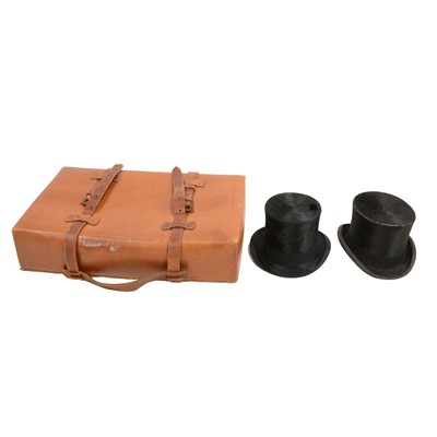 Lot 112 - Two top hats and a leather suitcase
