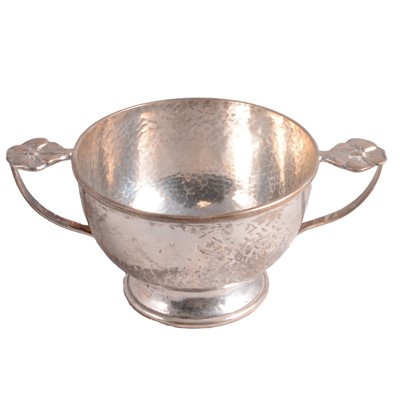 Lot 191 - A hand-beaten silver quaiche.