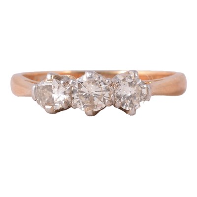 Lot 65 - A diamond three stone ring.