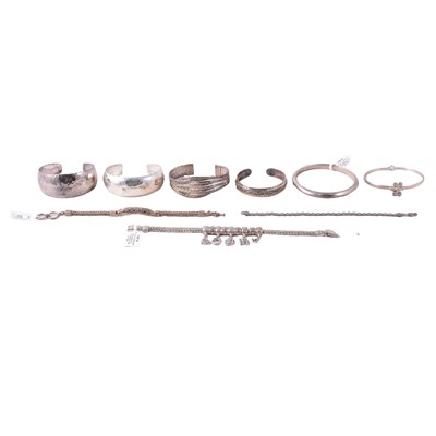 Lot 402 - Sixteen silver and white metal bracelets, bangles, cuff bangles, and sprung bangles.