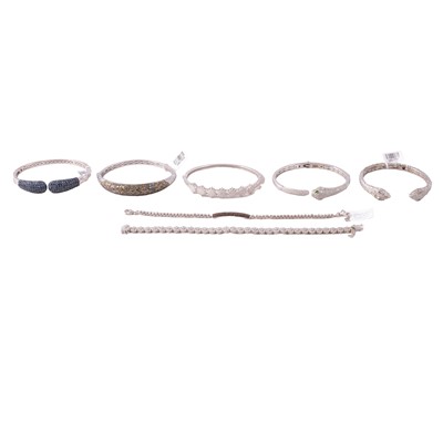 Lot 401 - A collection of diamond set silver and white metal half-hinged bangles, and bracelets.