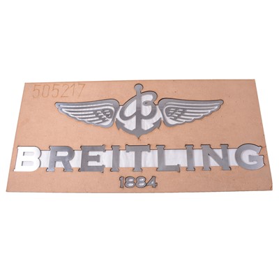 Lot 347 - Breitling - a silvered metal advertising display, and wooden laser-cut stencil.
