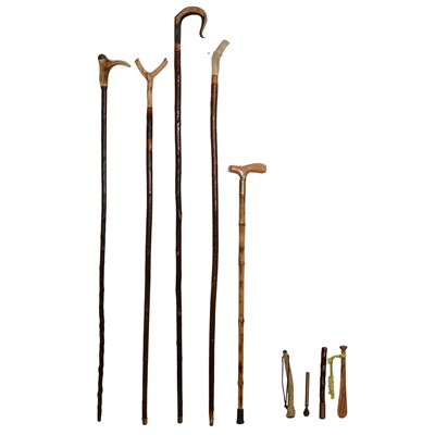 Lot 102 - Five walking sticks, one inscribed Holt Hall, and four fishing priests.