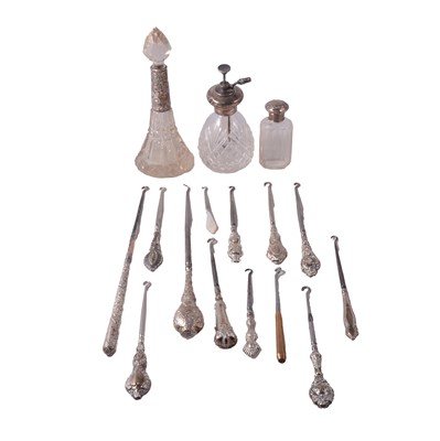 Lot 166 - Silver handled button hooks, plus three silver topped bottles