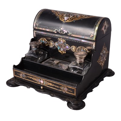Lot 94 - An inlaid black lacquer writing companion with two glass inkwells.