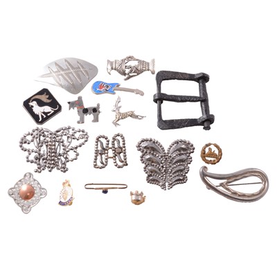 Lot 425 - Cut steel and metal buckles, metal badges and pins, military badge, and charms.