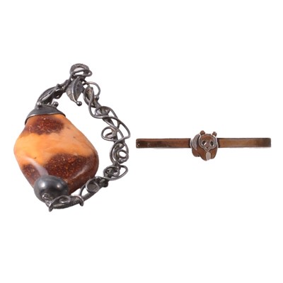 Lot 427 - Harald Popkiewicz - an amber and white metal pendant, and a silver-gilt bar brooch.